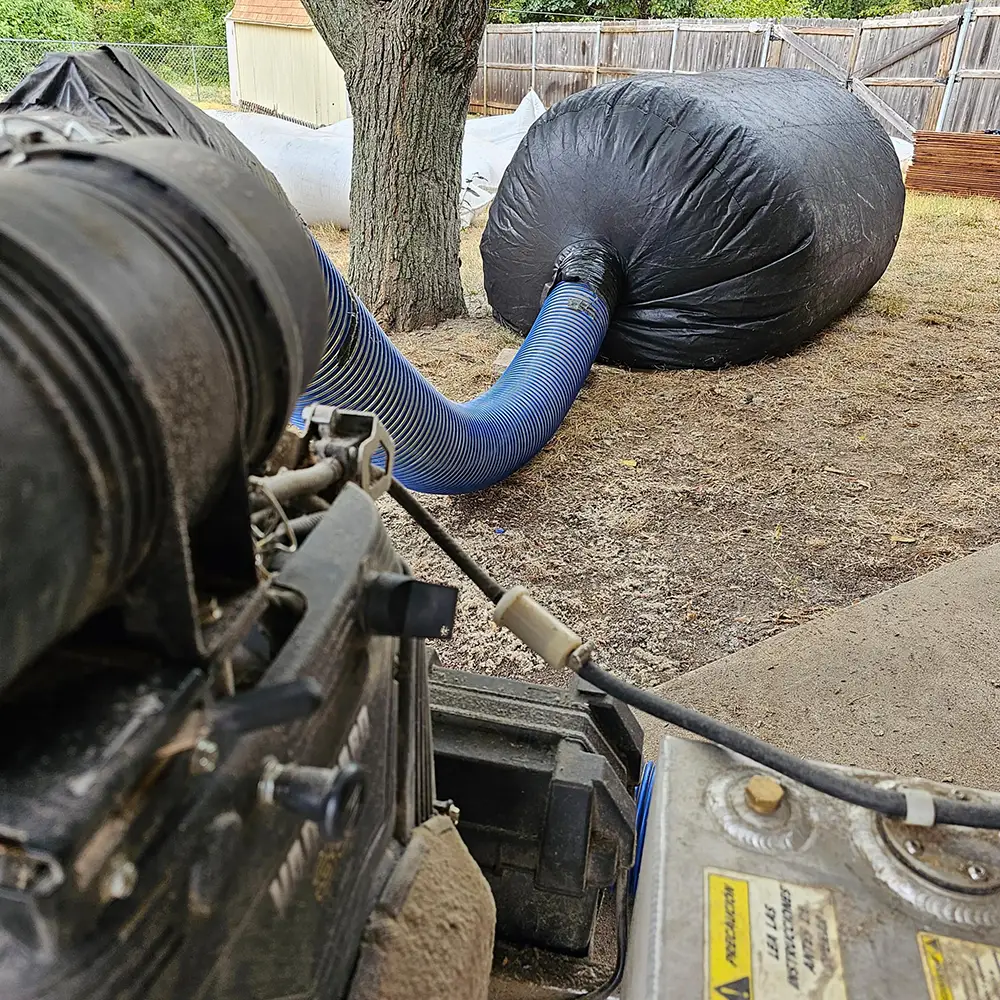 Dust Guard Pro bags positioned in yard during residential insulation removal