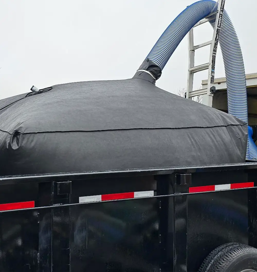 Dump trailer insulation bag being filled from top during commercial removal